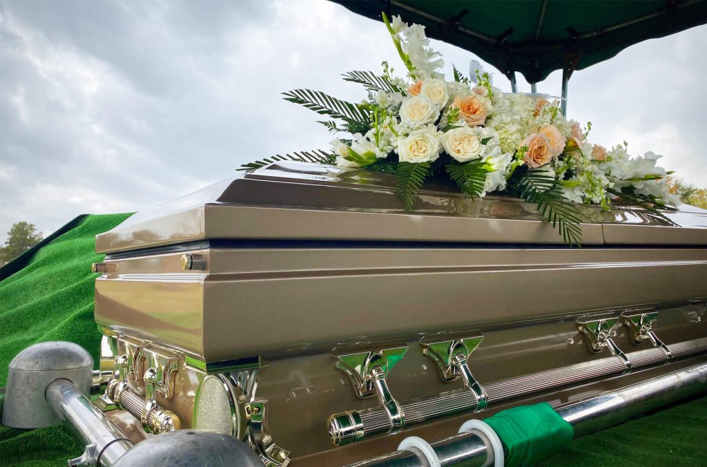 Casket with flowers placed on top of it